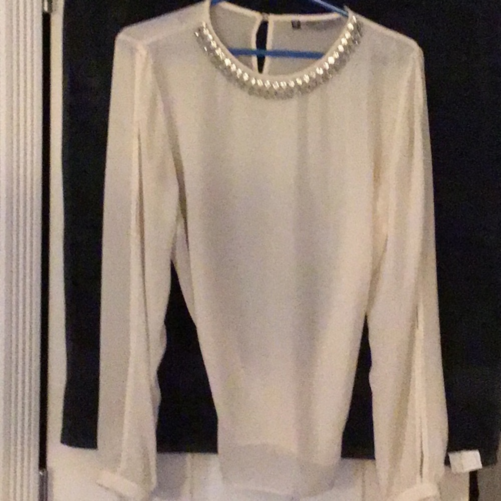 Cream color silk blouse. Arms have peekaboo